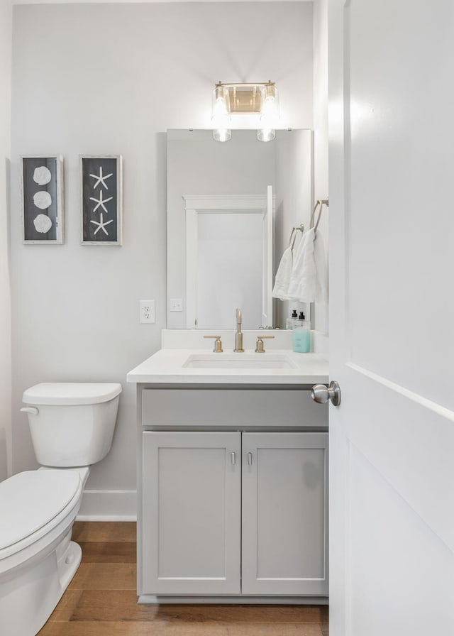 411 Katies Scenic Ct, Wando, SC 29492 - bathroom with toilet, vanity, wood finished floors, and baseboards