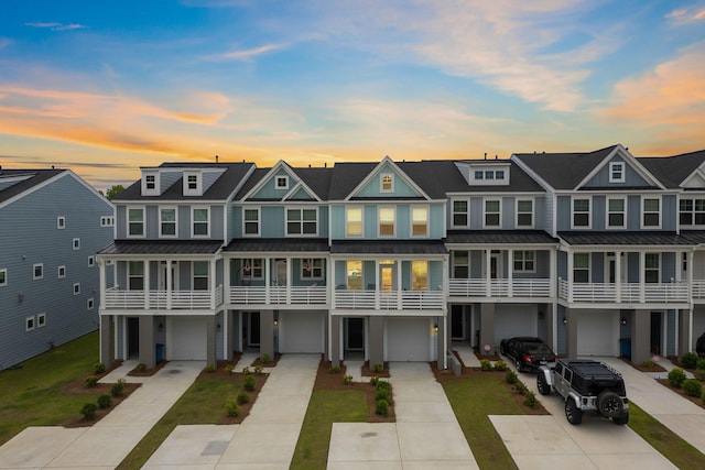 411 Katies Scenic Ct, Wando, SC 29492 - townhome / multi-family property featuring driveway, an attached garage, a standing seam roof, a residential view, and a shingled roof