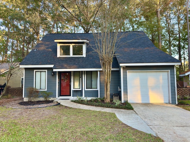 view of front of property featuring a garage and a front lawn