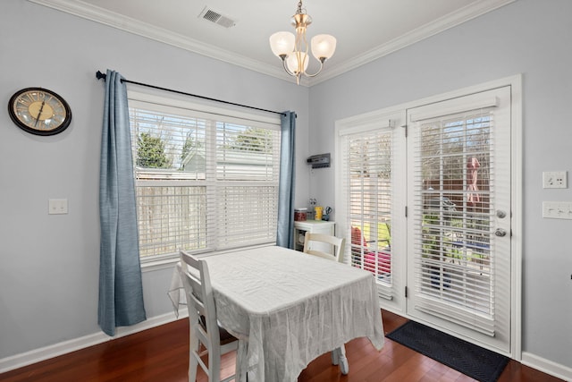 dining room featuring a notable chandelier, visible vents, crown molding, and dark wood-style flooring