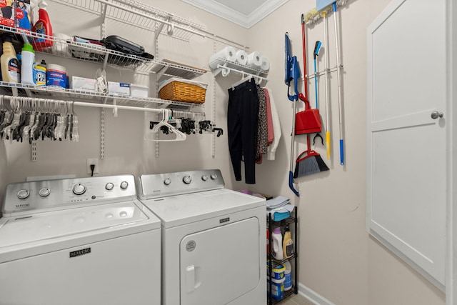 laundry area with laundry area, independent washer and dryer, crown molding, and baseboards