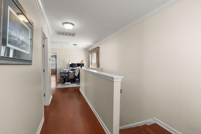 hall with an upstairs landing, visible vents, crown molding, and hardwood / wood-style floors