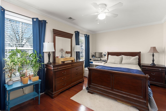 bedroom with ceiling fan, visible vents, dark wood-style floors, and crown molding