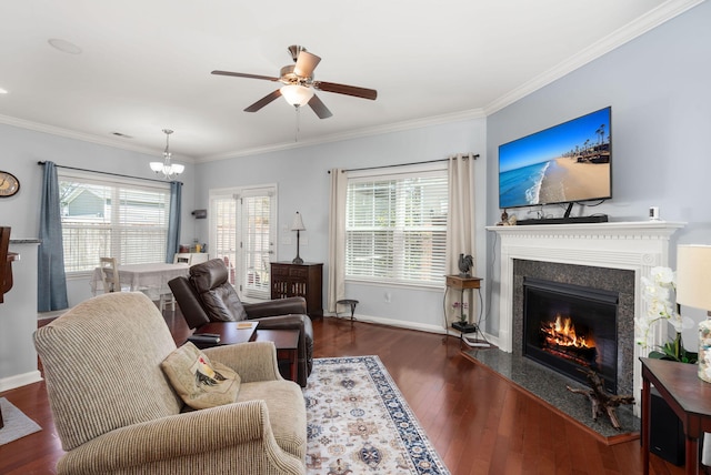 living area with crown molding, a fireplace, wood-type flooring, and a healthy amount of sunlight