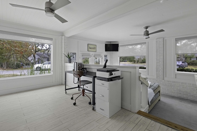 office area with beamed ceiling, a ceiling fan, light wood-type flooring, and brick wall