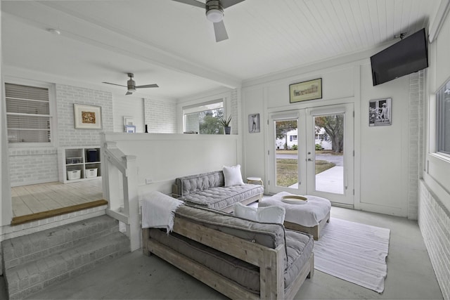 bedroom with access to exterior, brick wall, ceiling fan, beam ceiling, and french doors