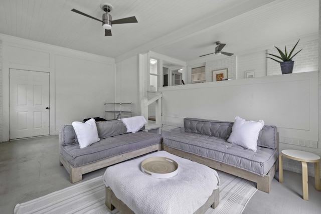 living area with concrete flooring and ceiling fan