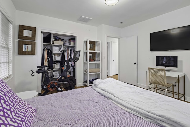 bedroom with a closet and visible vents