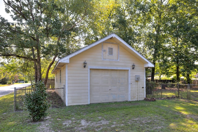 garage featuring wood walls and a yard