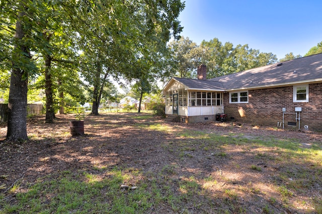 view of yard featuring a sunroom