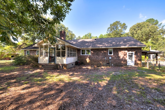 rear view of property with a sunroom