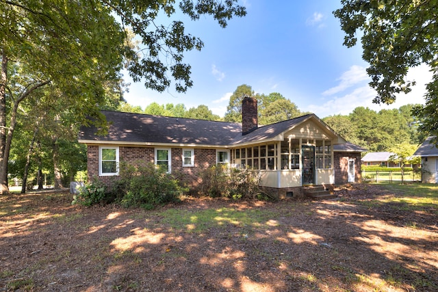 rear view of house with a sunroom