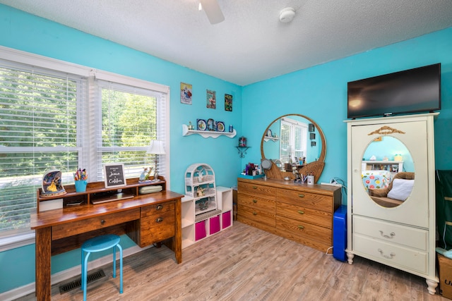 office space featuring a textured ceiling, ceiling fan, and wood-type flooring