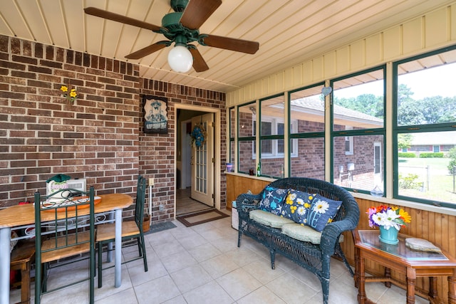 sunroom featuring a healthy amount of sunlight and ceiling fan