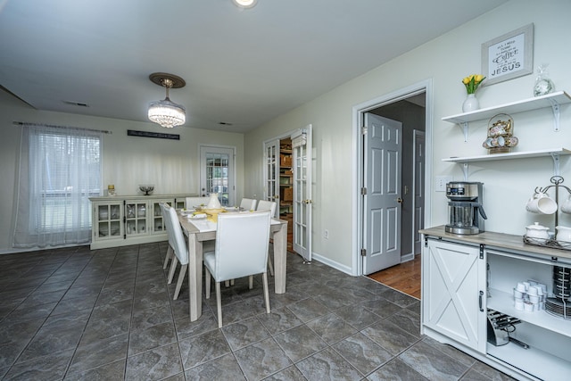 dining room featuring visible vents and baseboards