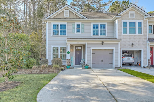 view of front facade featuring board and batten siding, driveway, and an attached garage