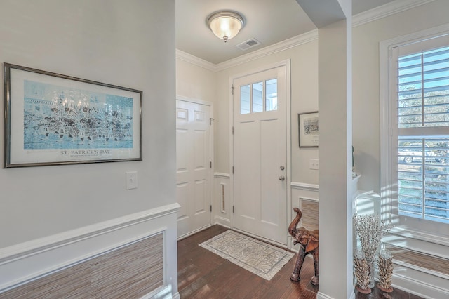 entrance foyer with visible vents, ornamental molding, and dark wood-style flooring