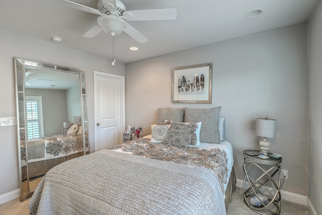 carpeted bedroom featuring baseboards and a ceiling fan