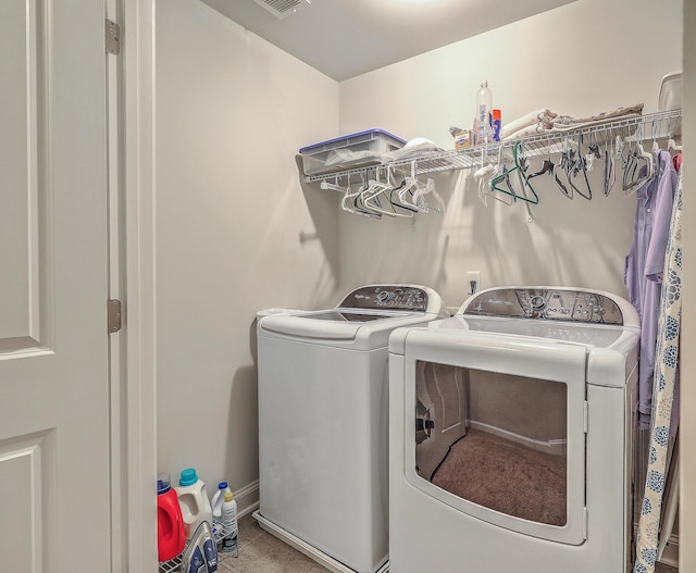 laundry area with laundry area, washer and clothes dryer, visible vents, and baseboards