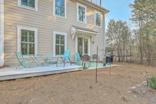 rear view of property featuring a wooden deck