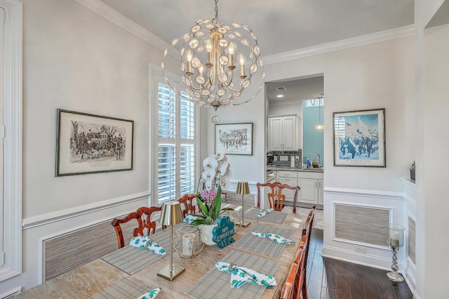 dining space featuring visible vents, a chandelier, dark wood finished floors, and ornamental molding