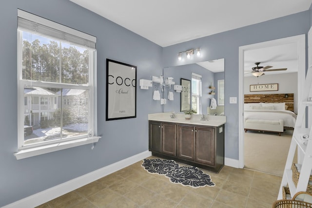 bathroom with tile patterned floors, a healthy amount of sunlight, and vanity