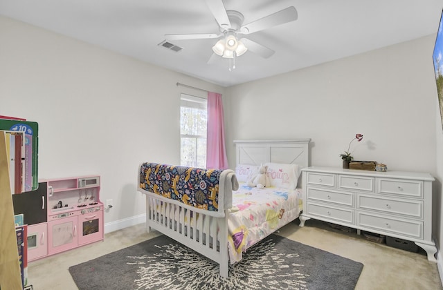 bedroom featuring light colored carpet and ceiling fan