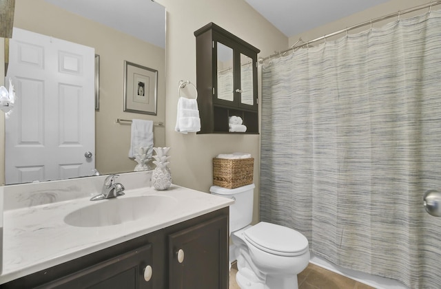 bathroom with vanity, tile patterned flooring, and toilet