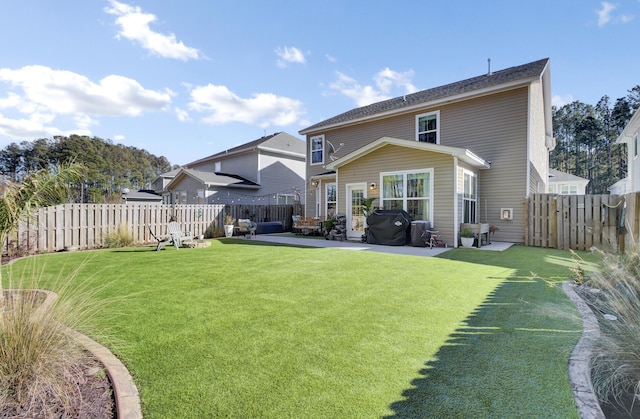 back of property featuring a patio area and a lawn