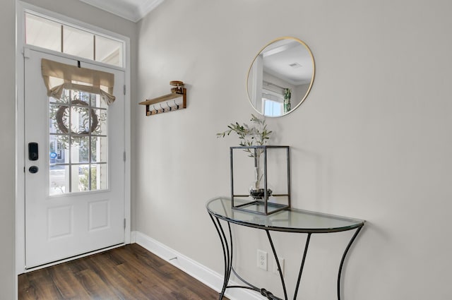 foyer entrance featuring ornamental molding and dark hardwood / wood-style floors