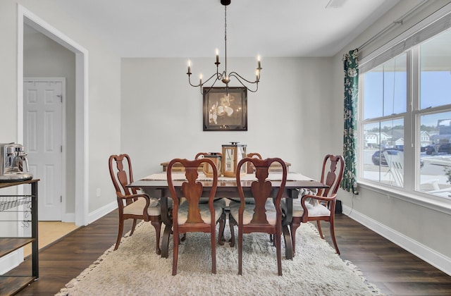 dining room featuring dark hardwood / wood-style floors and a notable chandelier