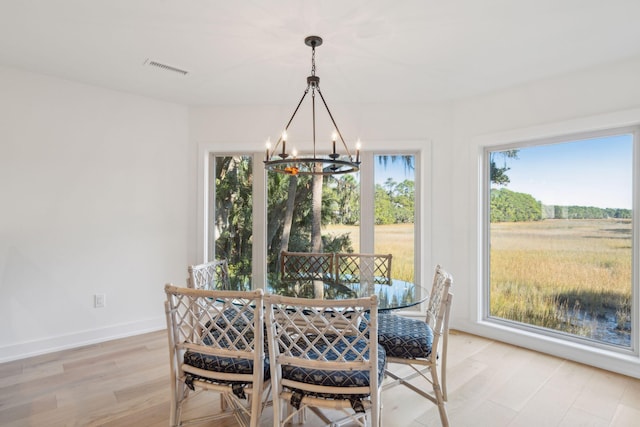 dining room featuring a chandelier and light hardwood / wood-style flooring