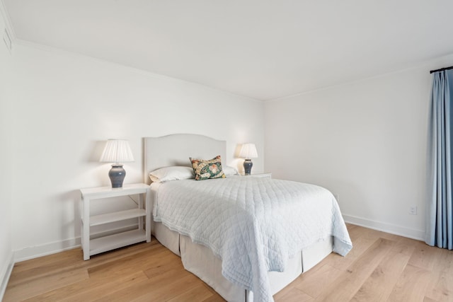 bedroom featuring crown molding and wood-type flooring