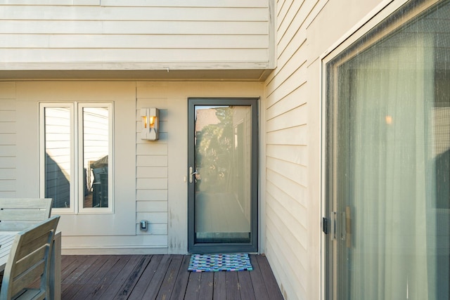 view of exterior entry featuring a deck