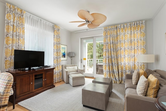 living room with ceiling fan and ornamental molding