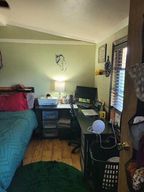 bedroom with light hardwood / wood-style flooring and vaulted ceiling