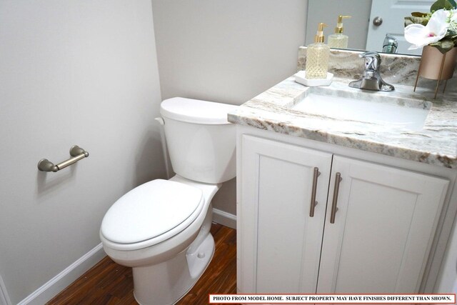 bathroom with vanity, hardwood / wood-style floors, and toilet