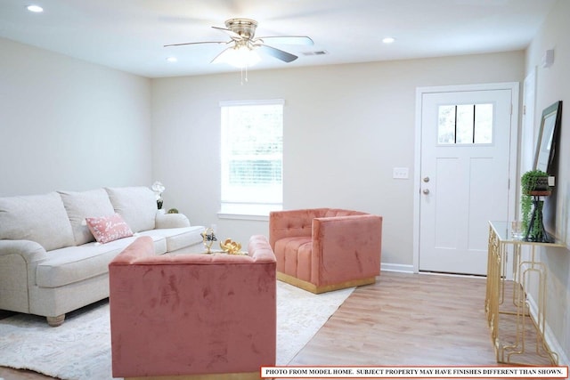 living room with ceiling fan and light wood-type flooring