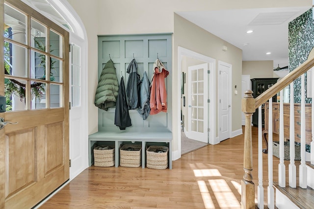 mudroom with wood finished floors and recessed lighting