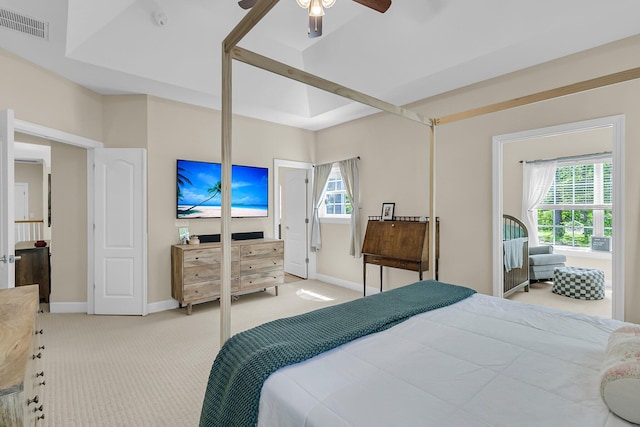 bedroom featuring light colored carpet, baseboards, and a ceiling fan