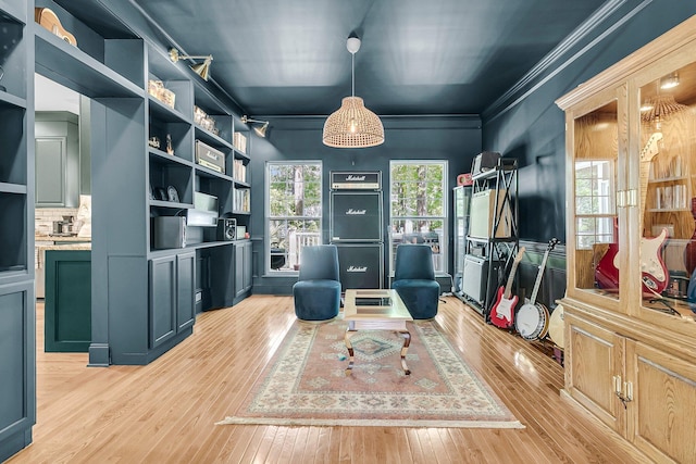 interior space featuring light wood-style flooring and crown molding