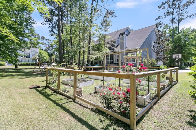 rear view of property with a garden, a lawn, and roof with shingles