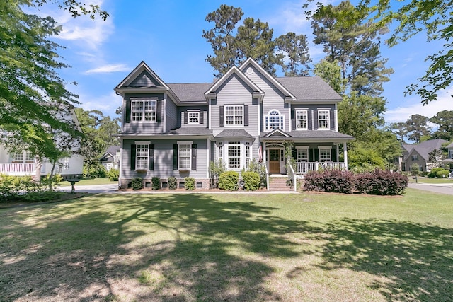 view of front facade with covered porch and a front lawn