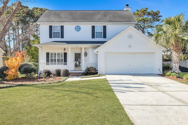 view of front property with covered porch, a front yard, and a garage