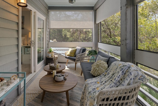 sunroom featuring an outdoor hangout area and plenty of natural light