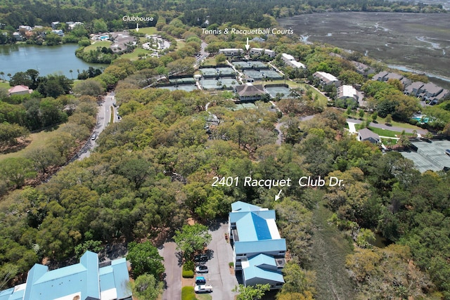 birds eye view of property with a water view, a view of trees, and a residential view