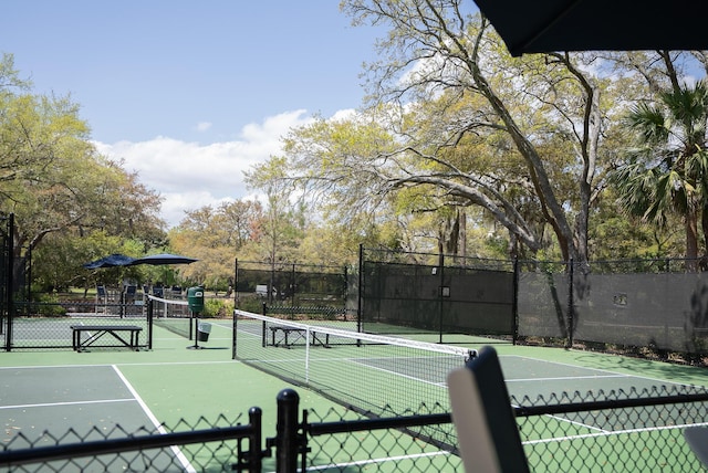 view of sport court featuring fence