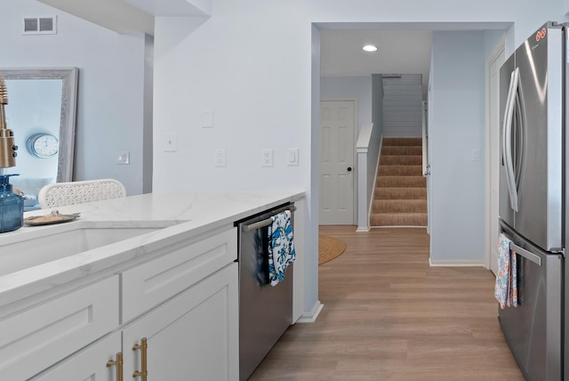 kitchen featuring recessed lighting, light wood-style flooring, white cabinetry, visible vents, and stainless steel appliances