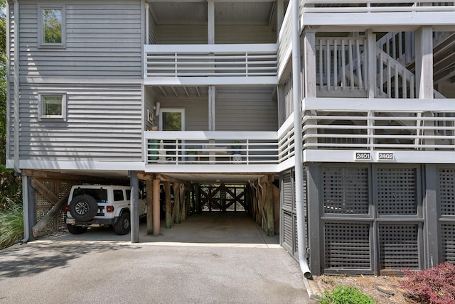 view of building exterior featuring a carport and driveway