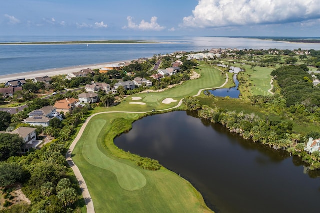 drone / aerial view with a residential view, view of golf course, and a water view